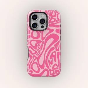 May include: A pink and light pink abstract pattern phone case. The case has a glossy finish and a black border. The design features swirling shapes and a camera cutout.