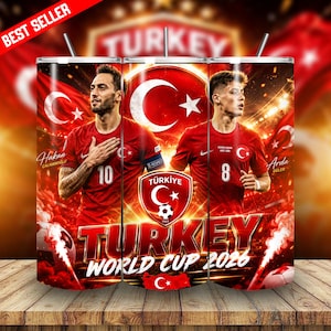 May include: A cylindrical tumbler featuring a red and white design with two soccer players in red jerseys, the Turkish national flag, a soccer crest, and the text Turkey World Cup 2026. The graphic includes stadium lighting and smoke effects.