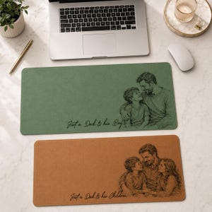 May include: Two rectangular desk mats. The top mat is green with a sketch of a father and son, and the text "Just a Dad & his Boy". The bottom mat is brown with a father and two children sketch, and the text "Just a Dad & his Children".
