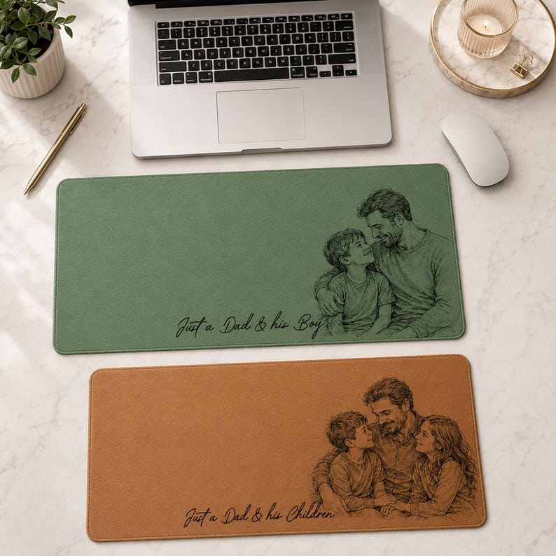 May include: Two rectangular desk mats. The top mat is green with a sketch of a father and son, and the text "Just a Dad & his Boy". The bottom mat is brown with a father and two children sketch, and the text "Just a Dad & his Children".