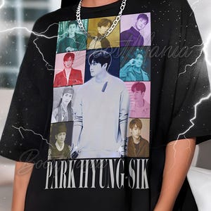 May include: Black t-shirt with a collage of images of Park Hyung Sik, and the name "PARK HYUNG SIK" printed in white at the bottom. The shirt has a crew neck and short sleeves.