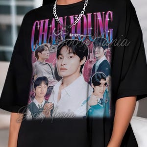 May include: Black t-shirt featuring a collage of images of a person, with the name "CHAN YOUNG" in a retro font. The shirt has a vintage aesthetic, with the text "Boost Mania" in a script font.