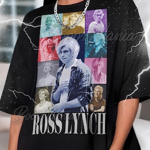 May include: Black t-shirt featuring a collage of images of Ross Lynch, with the name "ROSS LYNCH" printed in white block letters. The shirt has a crew neck and short sleeves. A silver chain necklace is visible.
