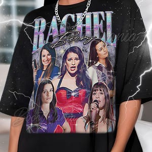 May include: Black t-shirt with a graphic of Rachel Berry from Glee. The design includes multiple images of the character, the name "Rachel Berry" in a stylized font, and a vintage aesthetic.