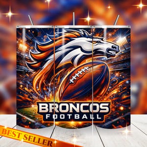 Puede incluir: Un vaso con un diseño vibrante con el logotipo de los Denver Broncos, una cabeza de caballo blanca y naranja y un balón de fútbol americano. Las palabras "BRONCOS FOOTBALL" se muestran debajo. El fondo tiene luces de estadio.