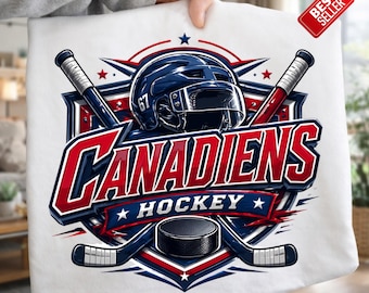 Puede incluir: Camiseta blanca con un diseño de hockey. El gráfico muestra un casco de hockey azul, palos de hockey cruzados y la palabra "CANADIENS" en rojo y azul. También se incluye un disco de hockey negro. Una etiqueta de "MÁS VENDIDO" está adjunta.
