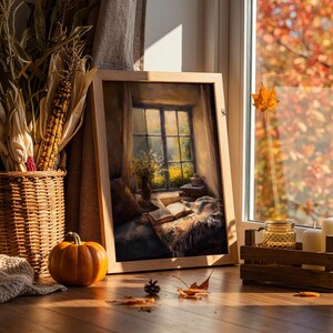 May include: A cozy autumn scene featuring a framed painting of a window with a view, a wicker basket with corn, a small pumpkin, candles, and a wooden crate. The scene is bathed in warm sunlight, with fall leaves visible outside the window.