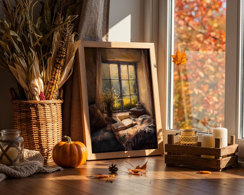 May include: A cozy autumn scene featuring a framed painting of a window with a view, a wicker basket with corn, a small pumpkin, candles, and a wooden crate. The scene is bathed in warm sunlight, with fall leaves visible outside the window.