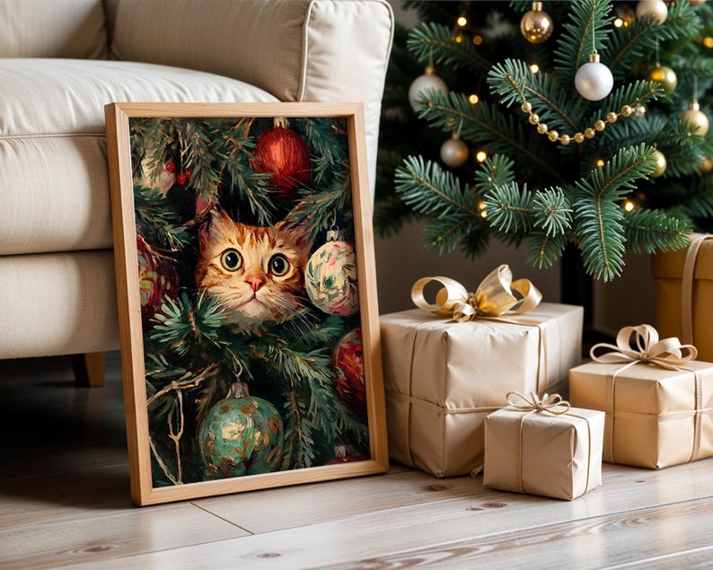 May include: A framed print featuring a ginger cat peeking through a Christmas tree, surrounded by ornaments. The cat has large, expressive eyes. The print is in a wooden frame, with a Christmas tree and wrapped gifts in the background.