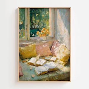 May include: A framed painting depicts a cozy reading nook bathed in sunlight. Open books rest on a cushioned window seat, surrounded by yellow and pink pillows. A vase of orange flowers sits on the windowsill, overlooking a lush green garden.