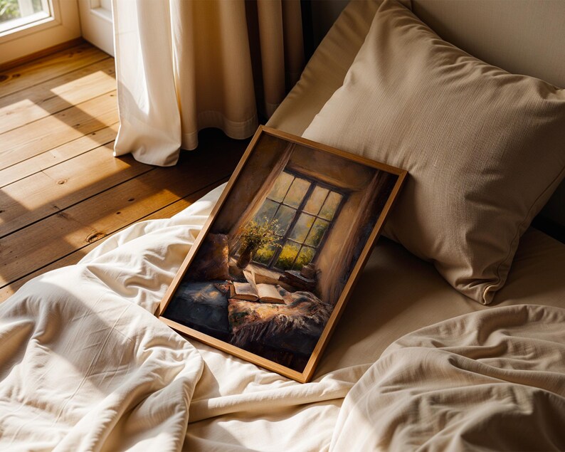 May include: A framed artwork depicting a cozy interior scene with a window view. The painting features a window with a view of a garden, an open book, and a vase of flowers. The artwork is set on a bed with pillows and a blanket.