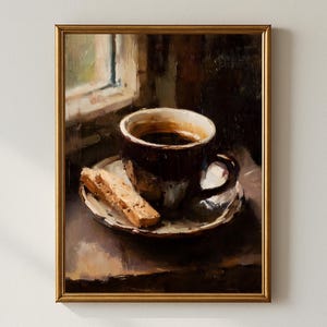 May include: A framed oil painting depicts a dark brown coffee cup filled with black coffee, resting on a saucer with a biscotti. The painting has a warm color palette, with a window in the background. The artwork is framed in a gold-colored frame.