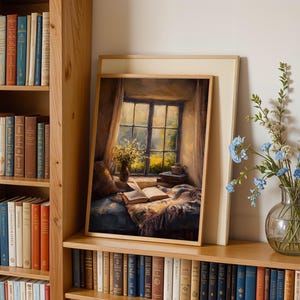 May include: A framed painting depicts a cozy reading nook with an open book, a window, and a vase of flowers. The painting is set on a wooden shelf, surrounded by bookshelves filled with books. A glass vase with blue flowers sits nearby.