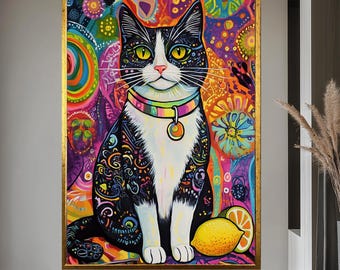 May include: A colourful cat painting in a gold frame. The black and white cat has yellow eyes and a patterned collar. The background is a mix of bright colours, with a lemon at the bottom. A unique piece of art for home decor.