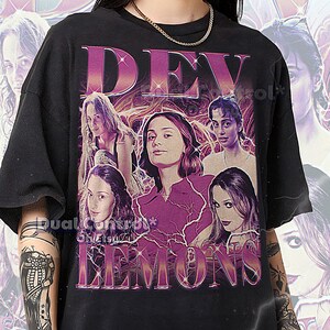 May include: Black unisex t-shirt featuring a graphic design with the text "DEV LEMONS" in a pink and purple retro font. The design includes images of women. The shirt is oversized and has short sleeves.