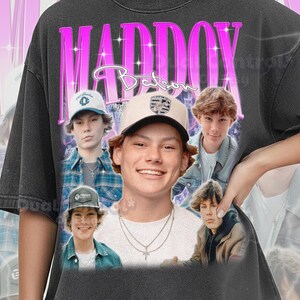 May include: Dark gray Comfort Color Pepper sweatshirt featuring a collage of images of a young man. The word "MADDOX" is in large, bright pink letters above the images, with the name "Batson" in a script font below. The sweatshirt has a vintage, distressed look.