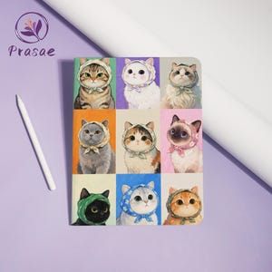 May include: A colorful notebook featuring nine cat portraits, each wearing a bonnet and bow. The cats have different fur patterns and colors, set against a variety of pastel backgrounds. A white stylus pen rests on the purple surface.