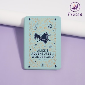 May include: A rectangular, pale blue item with the text "ALICE'S ADVENTURES in WONDERLAND" and an illustration of Alice falling. The design includes gold accents and decorative elements. The item is a book or a case.