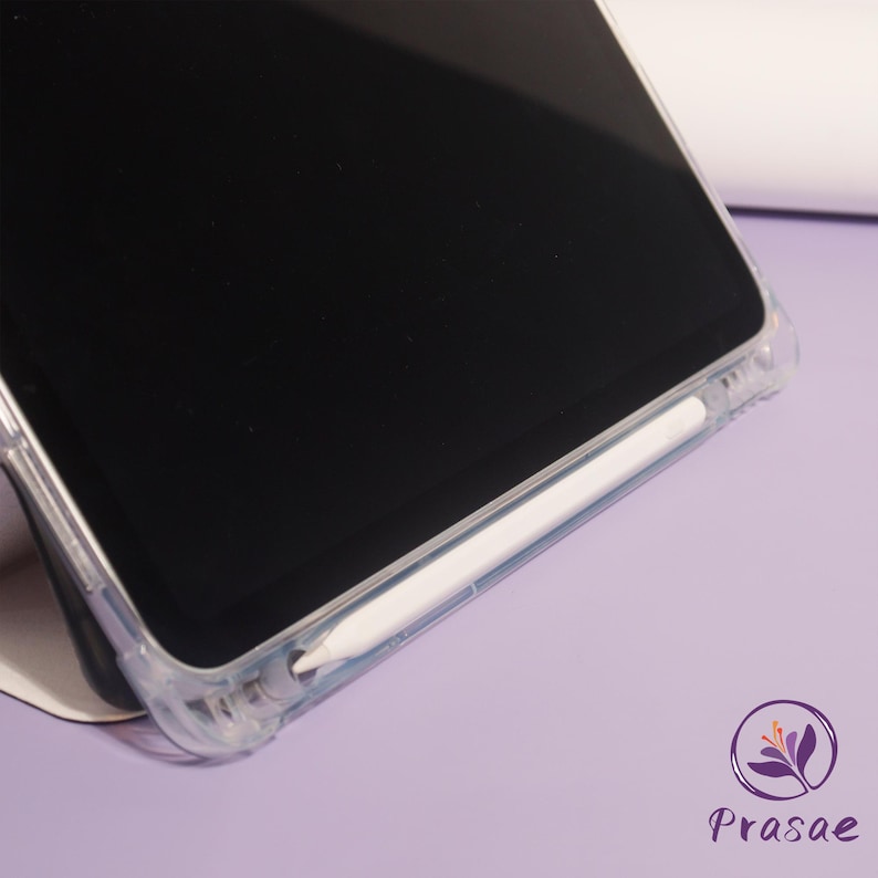 May include: A clear phone case with a white stylus. The phone screen is black. The case is on a light purple surface. The logo for Prasae is in the bottom right corner.