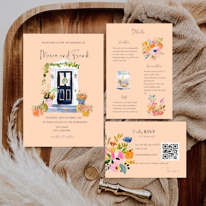May include: A wedding invitation suite with a watercolor design. The invitation features a door with floral arrangements and pumpkins. The details card and RSVP card are also included, with floral accents and a QR code for online RSVP.