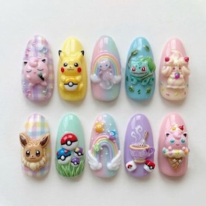 May include: A set of ten artificial nails, each adorned with a different 3D design. The designs feature various colorful Pokémon characters, rainbows, and other whimsical elements. The nails are oval-shaped and painted in pastel colors.