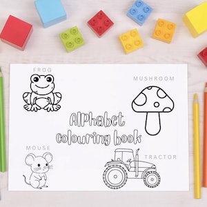 May include: Black and white coloring book page with illustrations of a frog, mushroom, mouse, and tractor. The title of the book is "Alphabet colouring book".