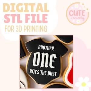 May include: Digital STL file for 3D printing. The image shows a cookie shaped like a baby onesie, decorated with black icing and the words "ANOTHER ONE BITES THE DUST" in white. The background is light pink.