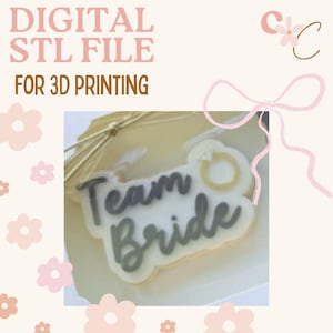 May include: Digital STL file for 3D printing. The image shows a design with the words "Team Bride" in grey script, with a ring graphic. The design is on a white background with a light pink bow and floral accents.