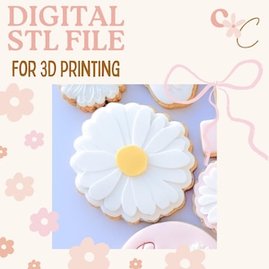 May include: Digital STL file for 3D printing. The image shows daisy-shaped cookies with white petals and yellow centers. The cookies are decorated with white icing and sit on a light purple surface. The background has a floral design.