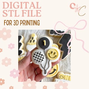 May include: A selection of decorated sugar biscuits, including a balloon-shaped biscuit with the number 1, a smiley face, and a checkered design. The biscuits are decorated with black, white, and yellow icing. Text in the image reads "DIGITAL STL FILE FOR 3D PRINTING".