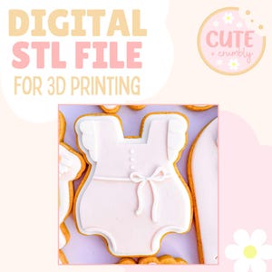 May include: Digital STL file for 3D printing. The image shows a baby onesie cookie cutter design. The onesie is light pink with white accents and a bow. The text "DIGITAL STL FILE FOR 3D PRINTING" is at the top.