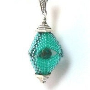 May include: A teal blue beaded pendant with a silver cap and a silver chain.