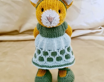 Ginger girl cat in green and blue dress