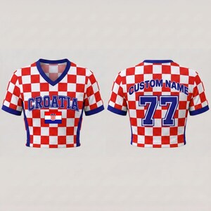 May include: A V-neck crop top featuring a red and white checkerboard pattern. The front displays the text CROATIA in blue with a small Croatian flag. The back shows the text CUSTOM NAME and the number 77 in blue with white outlines.