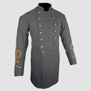 May include: A gray wool frock coat with gold braid trim on the sleeves and brass buttons. The coat has a stand-up collar and a double-breasted closure.