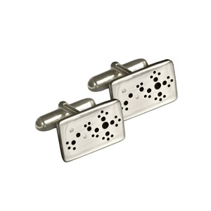 May include: A pair of silver cufflinks with a rectangular design. Each cufflink features a pattern of small and large black dots. The cufflinks have a polished finish and a classic, elegant style.