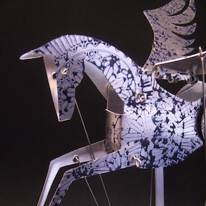 Pegasus Automata in aluminum stamped in blue.