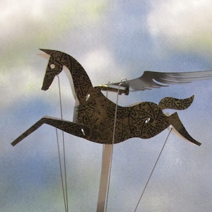 Black and gold Pegasus automata with black base