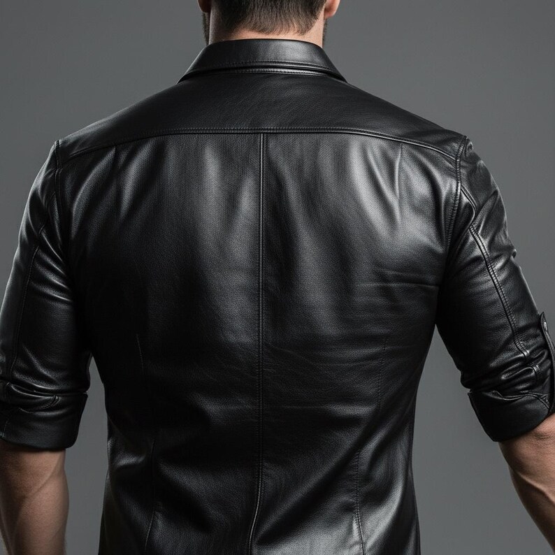 May include: A black leather shirt with a collared neckline and long sleeves. The shirt has a buttoned cuff detail and a tailored fit. The back of the shirt features vertical seams for a structured look. The shirt is made of a smooth, shiny material.
