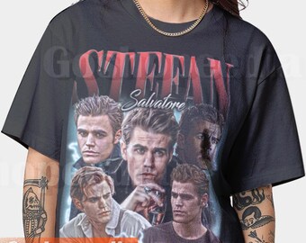 May include: Black t-shirt featuring a collage of images of a man with the name "STEFAN" in red letters above and "Salvatore" in white script. The shirt has a vintage, distressed look.