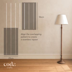 May include: A sample of wallpaper, 29cm wide and 56cm high, with a repeating pattern of white floral designs on a gray background. The text "Align the overlapping pattern to create a seamless repeat" is visible. A floor lamp is in the background.