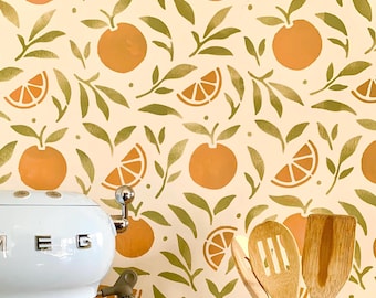 May include: A kitchen scene featuring a white appliance with the letters "M E G" on the front. The background is a repeating pattern of orange fruits and green leaves on a cream-colored surface. Wooden kitchen utensils are in the foreground.