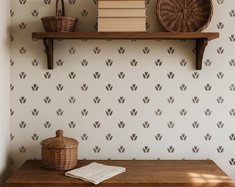 May include: A wooden shelf mounted on a wall with a repeating dark gray tulip pattern. The shelf holds a small woven basket, a stack of four beige books, and a round woven tray. Below, a wooden dresser features a woven lidded basket and a cloth.
