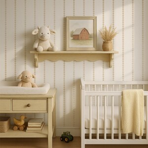 May include: A nursery scene with a white crib, changing table, and a shelf. The shelf holds a stuffed cow and a framed painting of a red barn. A yellow blanket hangs on the crib, and a stuffed lamb sits on the changing table.