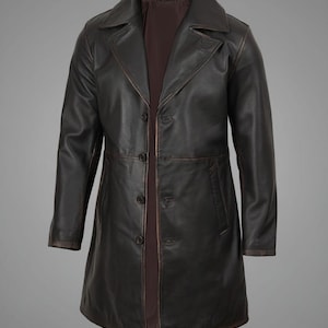May include: A dark brown leather coat with a classic design. The coat features a notched collar, button closure, and two front pockets. The coat is approximately 40 inches long.