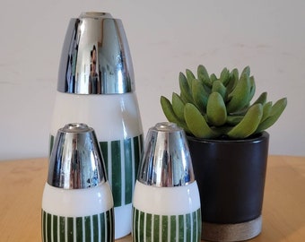May include: Set of three vintage glass salt and pepper shakers with green and white striped designs and silver tops.