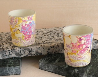 Delicate lacy pinks, lavenders and golds offer a glow reminscent of alabaster from these hand marbled silk votives from Brooklyn Marbling