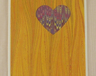 SHC119  Heart Card of Yellows holds up a marbled purple Heart.