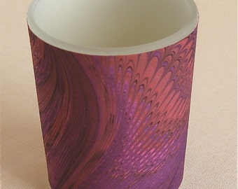 Deep purples swirl around a votive light