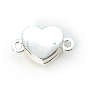 May include: Silver heart-shaped clasp with two loops for attaching jewelry.